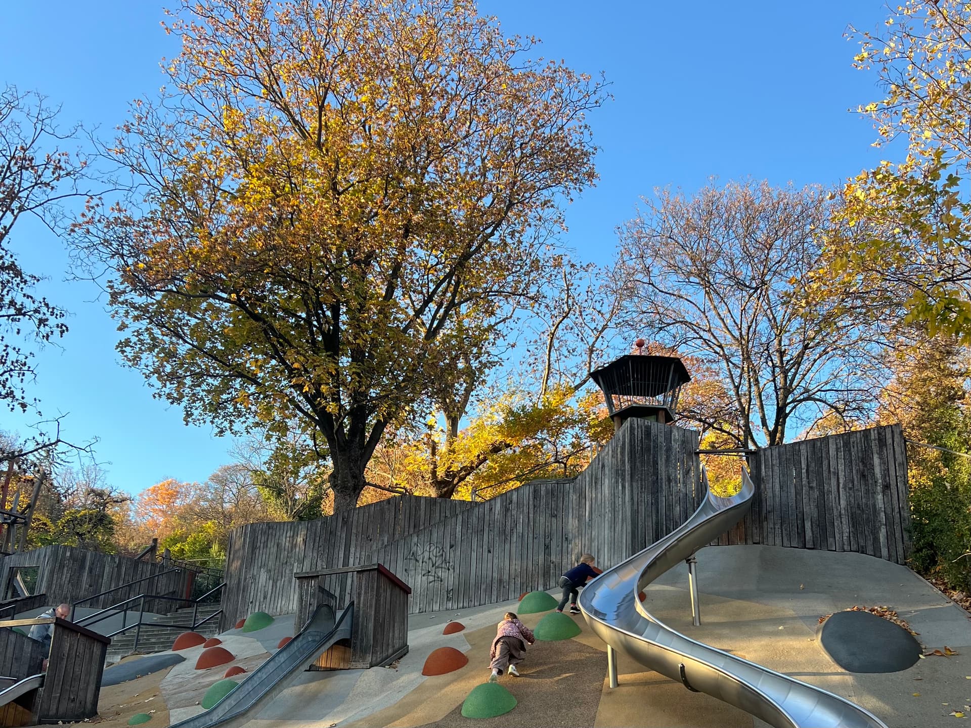 Children playing on a slide at an adventure playground
